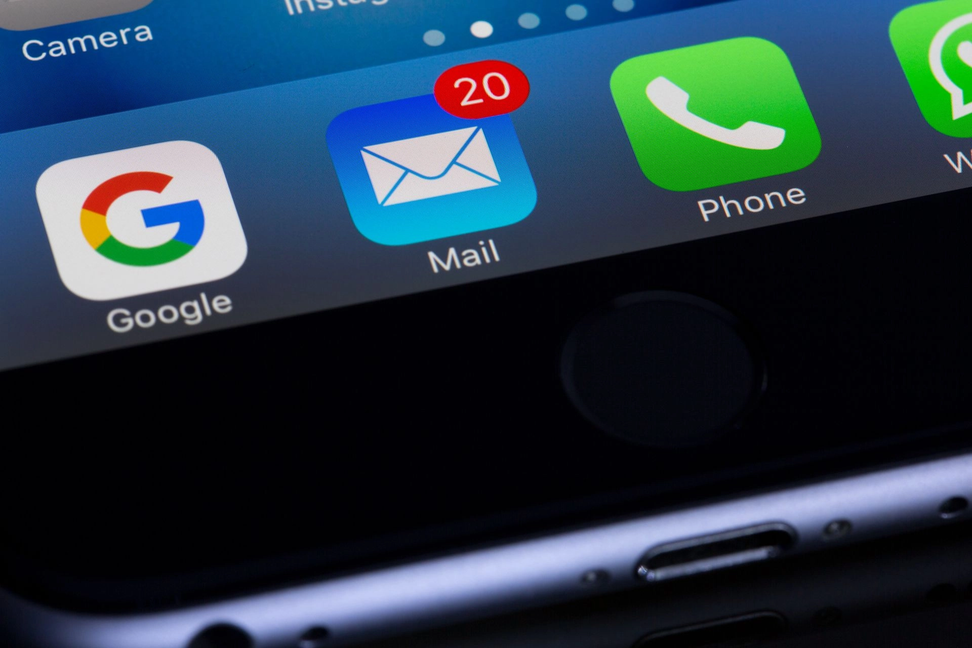 Close-up of a smartphone home screen with the Mail app icon showing 20 unread messages, next to the Google and Phone apps.